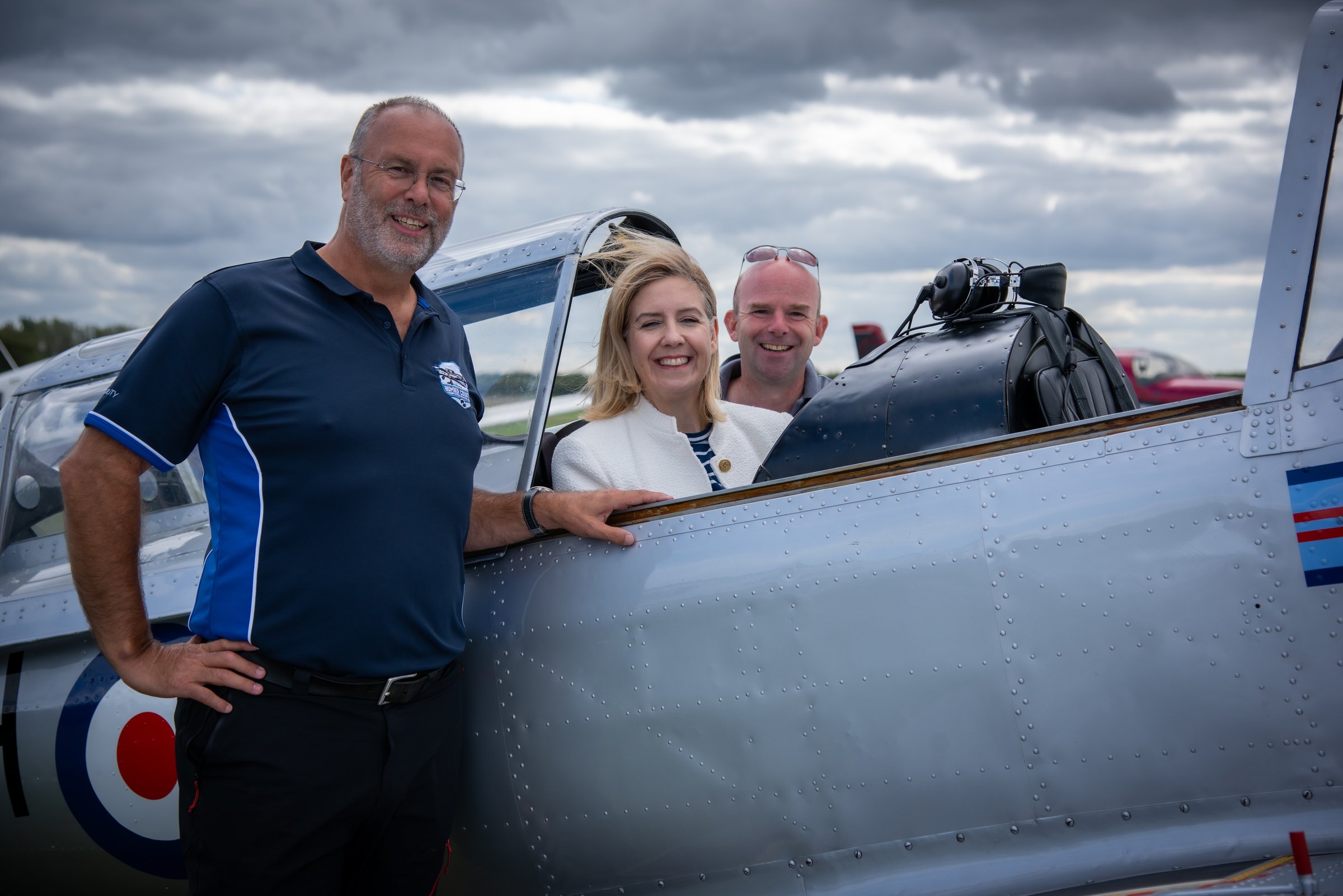 Three people beside an open aircraft at the Wickenby launch. Credit: Nigel Harrison.